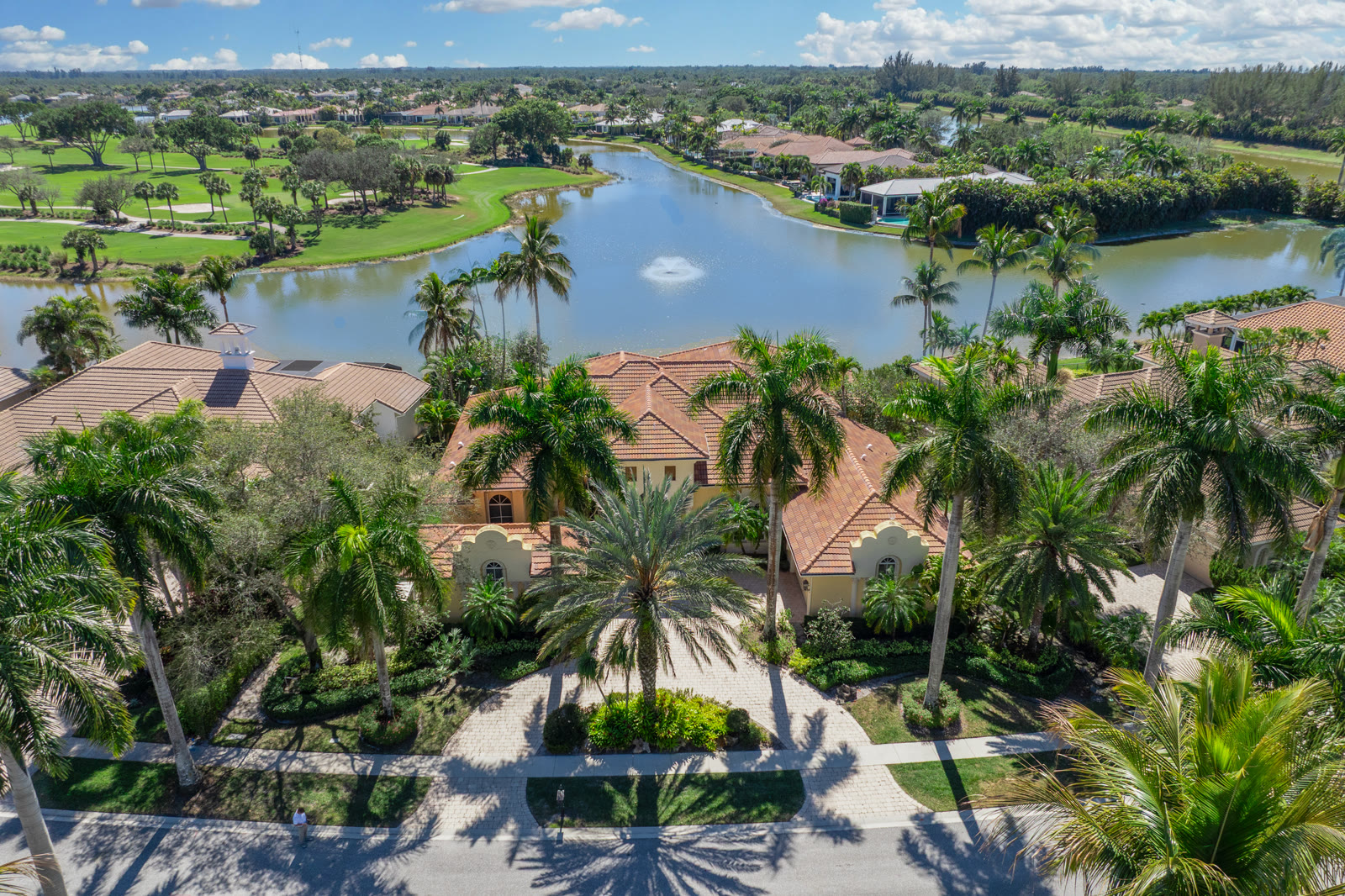 Aerial drone photograph of a lakefront estate on a golf course