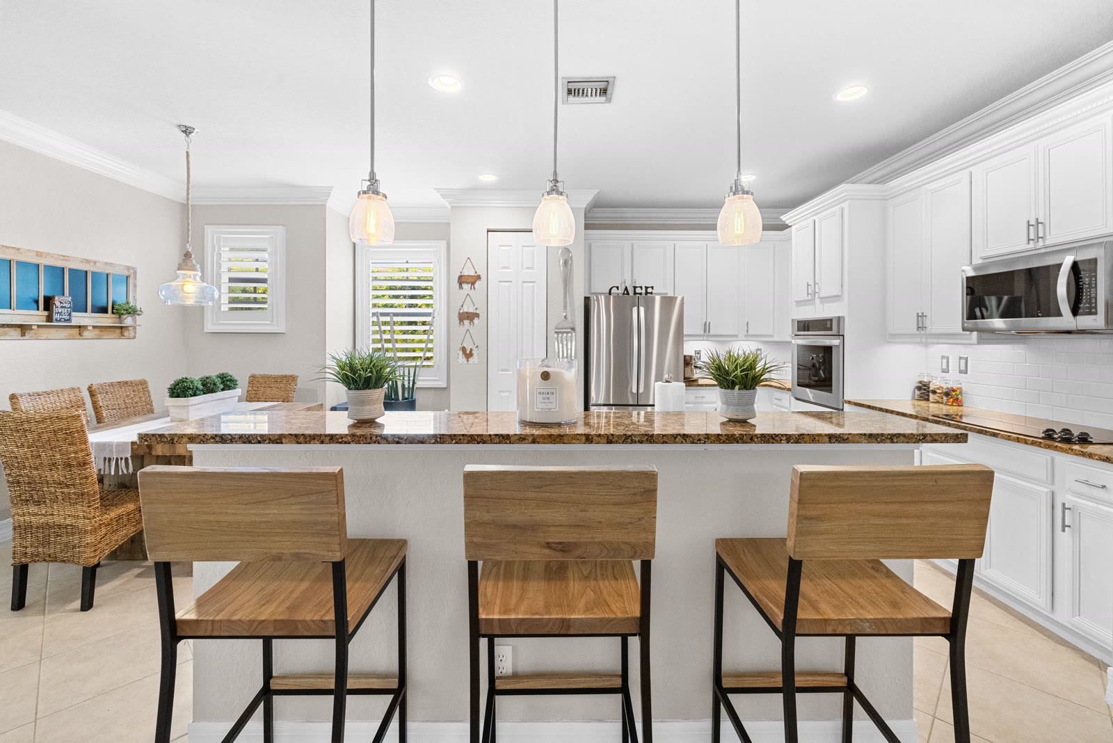 Dining area with wood table and bench seating in a Canterbury home, Abacoa, Jupiter FL