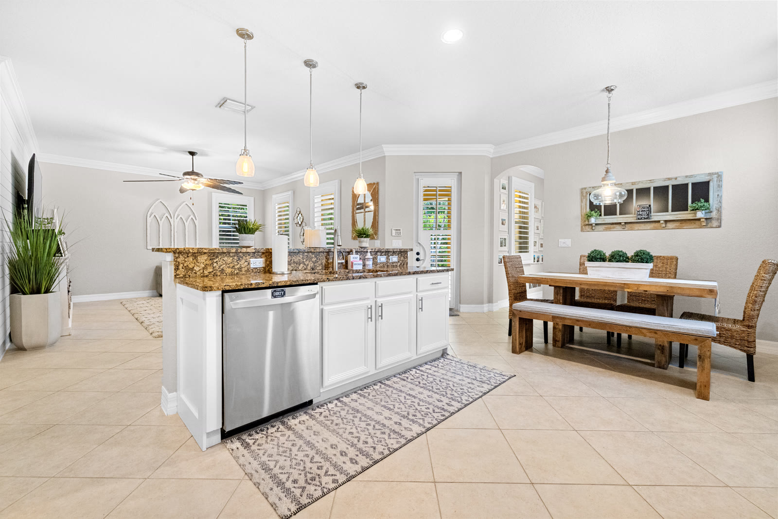 White farmhouse-style kitchen with granite countertops in a Canterbury home, Abacoa, Jupiter FL