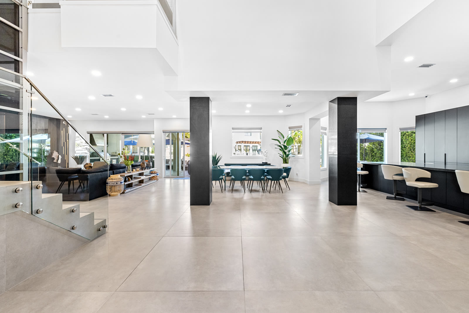 Wide entrance overview of the living, dining, and kitchen bar areas in a Boca Raton home