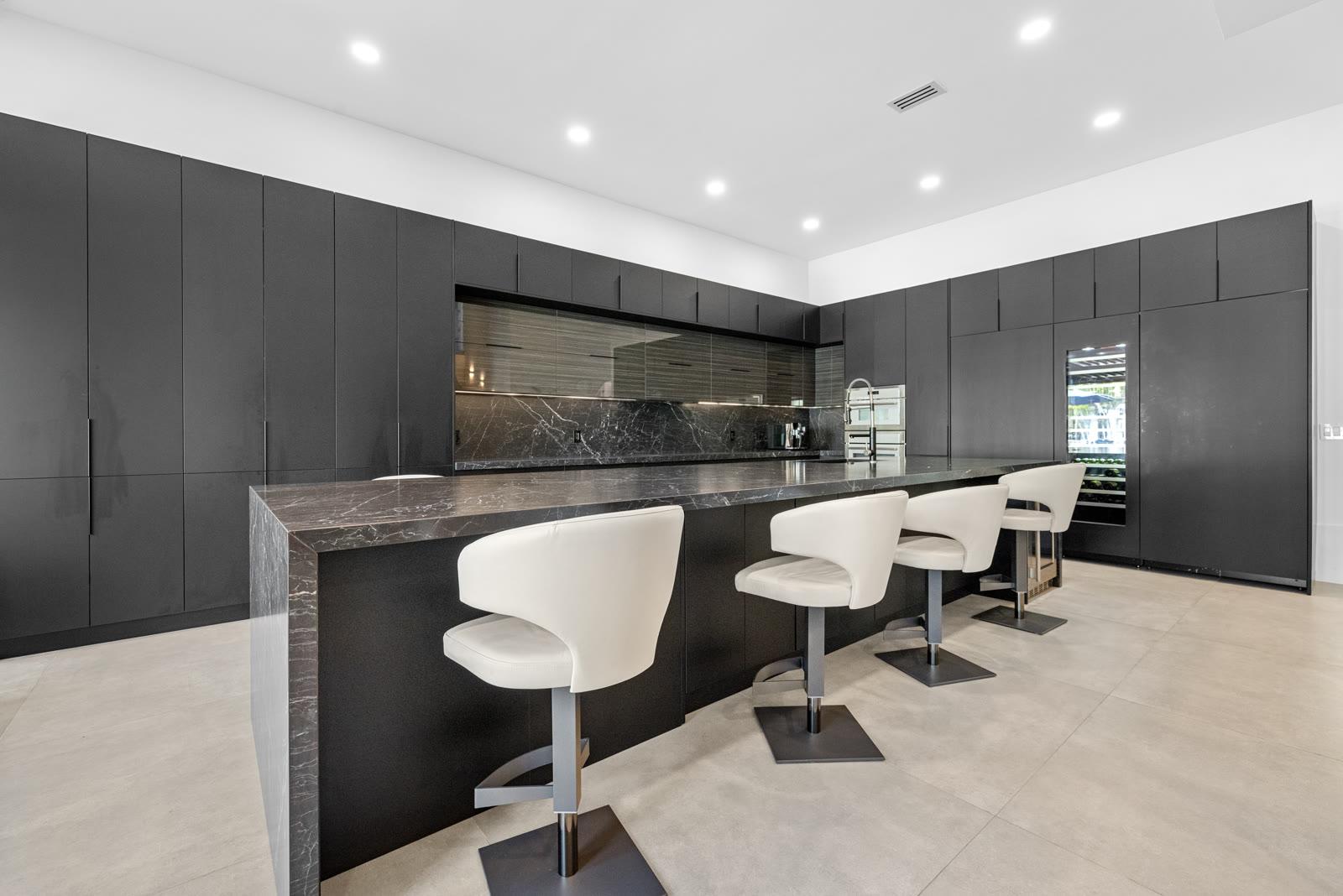 Black marble kitchen bar, alternate angle, in a Boca Raton home