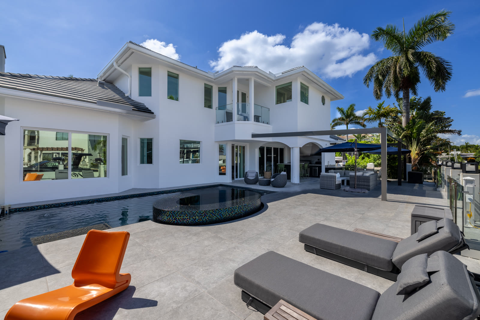 Waterfront pool and outdoor entertaining area at a Boca Raton home